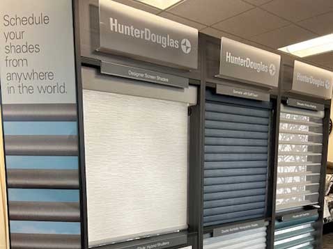 Store interior showcasing several different types of window coverings