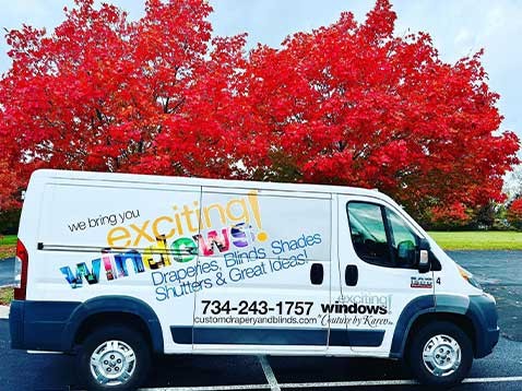 Company vehicle parked by a large tree
